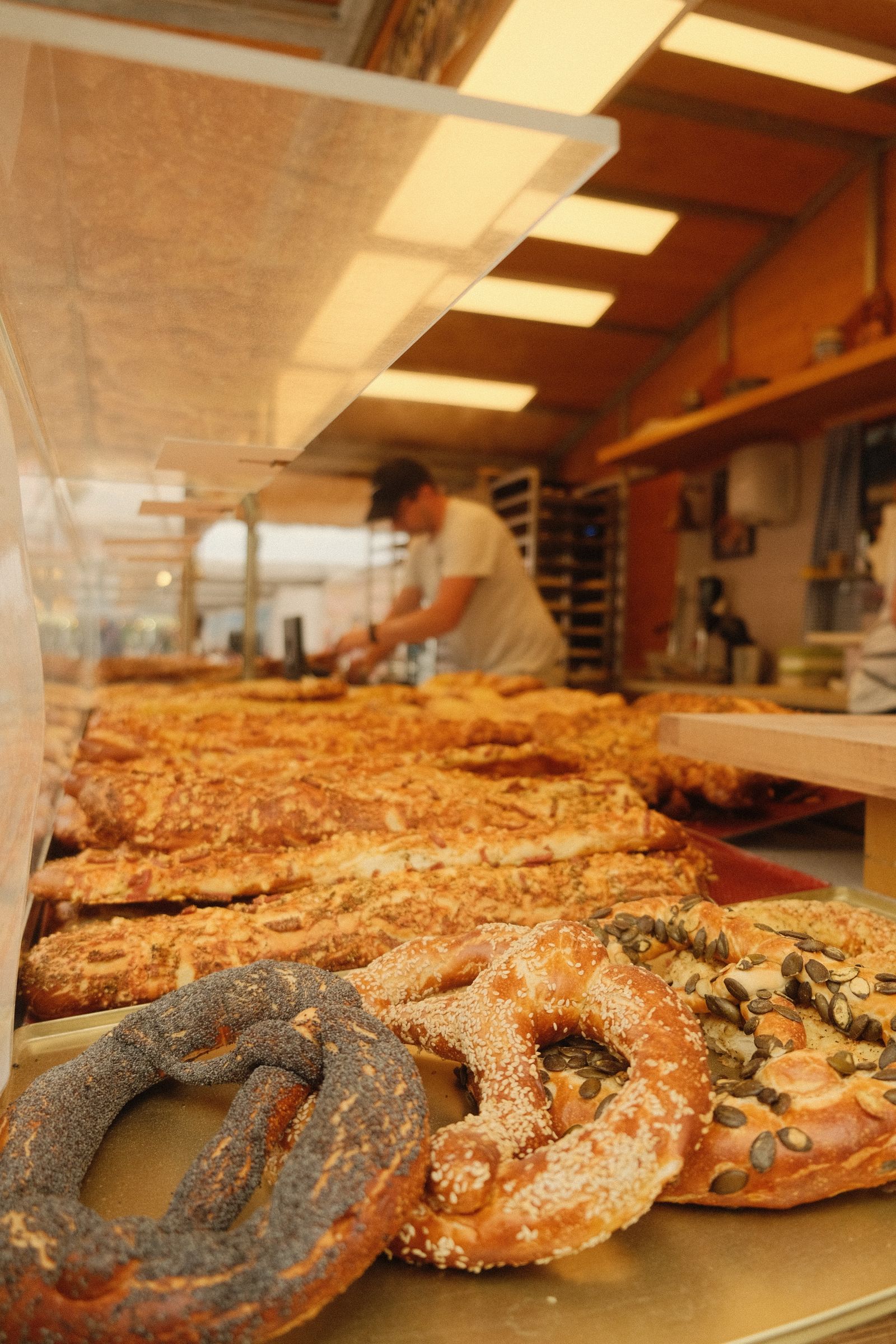 Freshly baked pretzels and savory pastries at a market counter